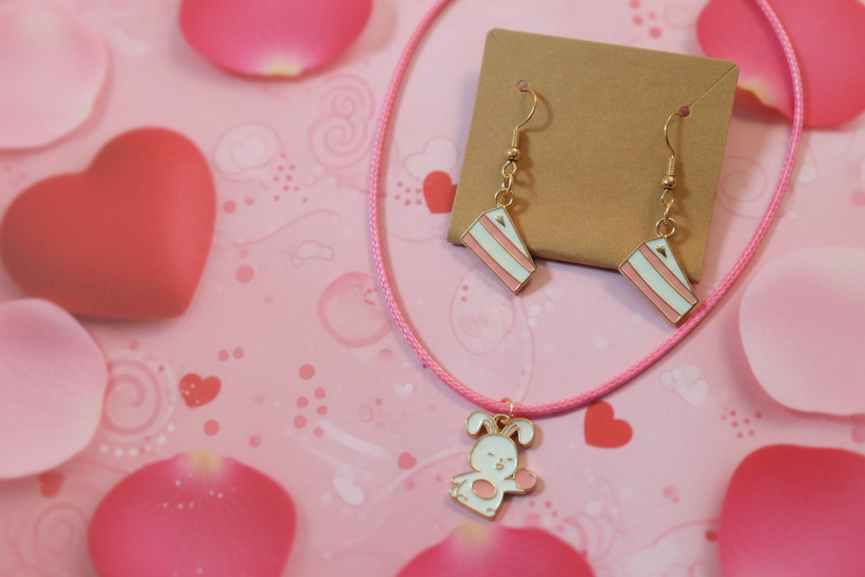 Necklace with a pink cord and cartoon character charm on a wooden surface